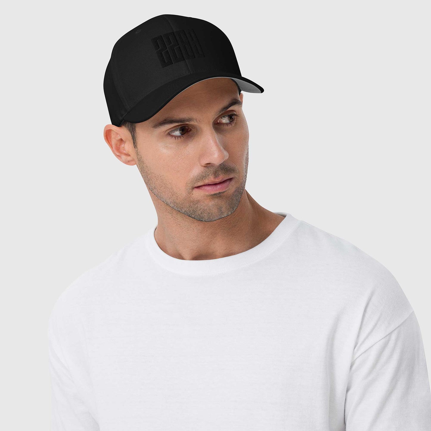 Black fitted baseball hat with subtle embroidery front and back