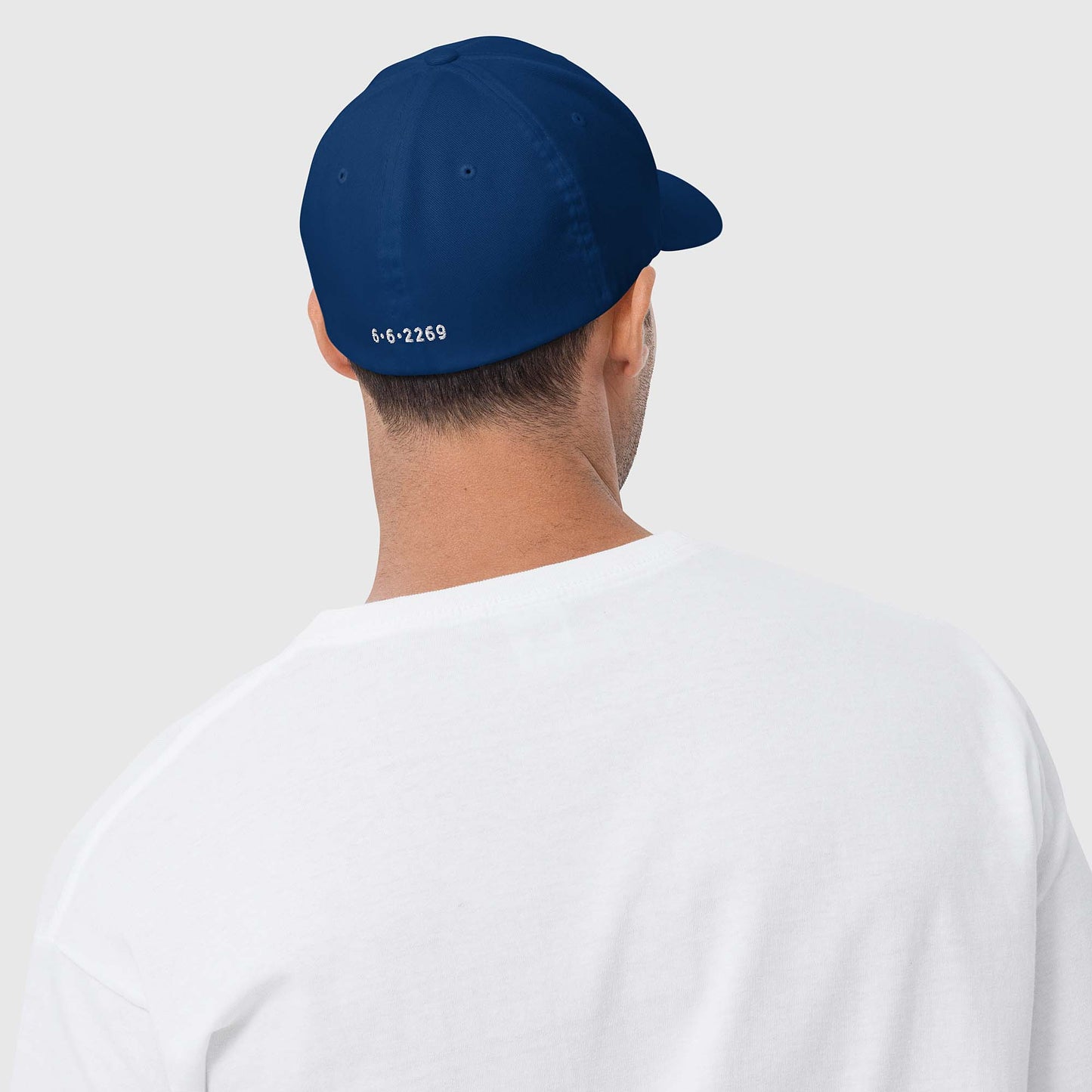 Royal blue fitted baseball hat with white embroidery front and back