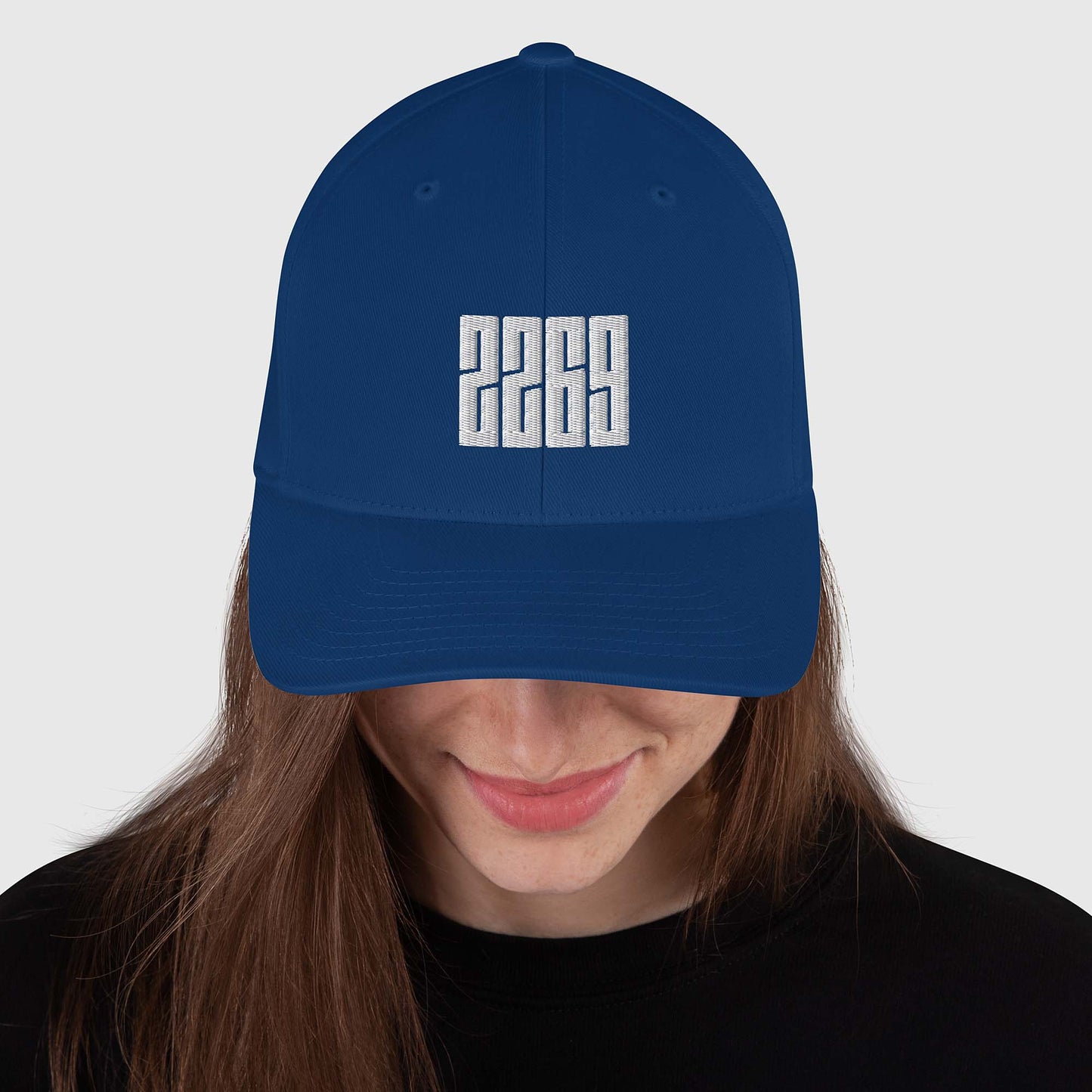Royal blue fitted baseball hat with white embroidery front and back