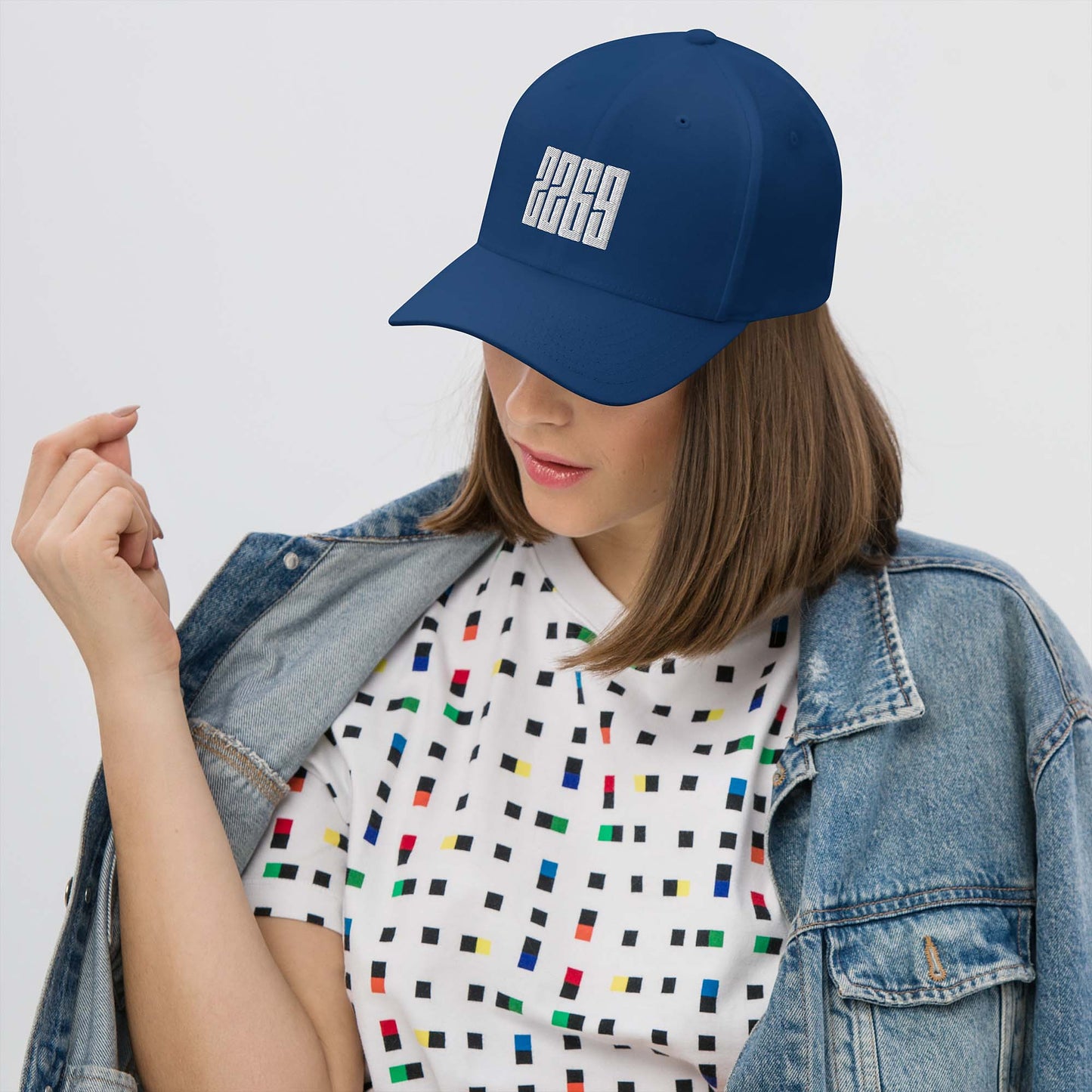 Royal blue fitted baseball hat with white embroidery front and back