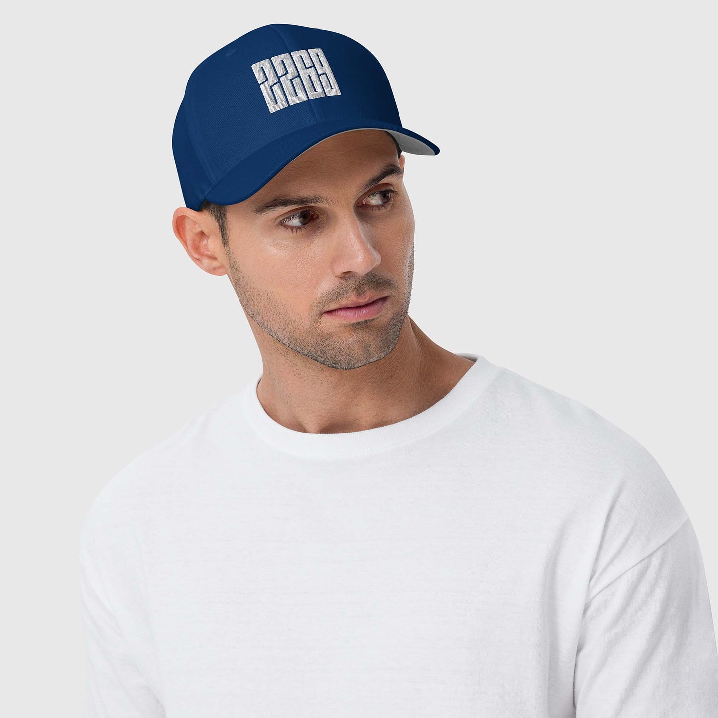 Royal blue fitted baseball hat with white embroidery front and back