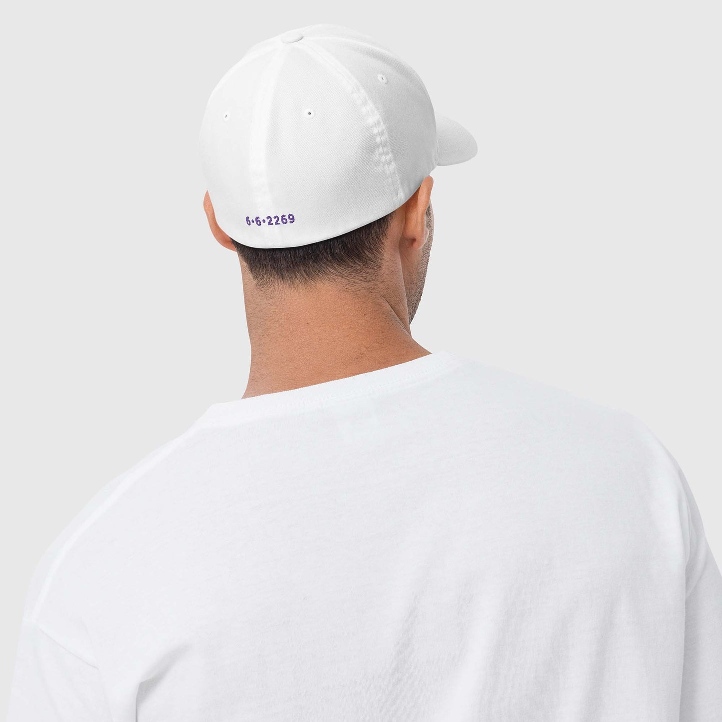 White fitted baseball hat with purple embroidery front and back