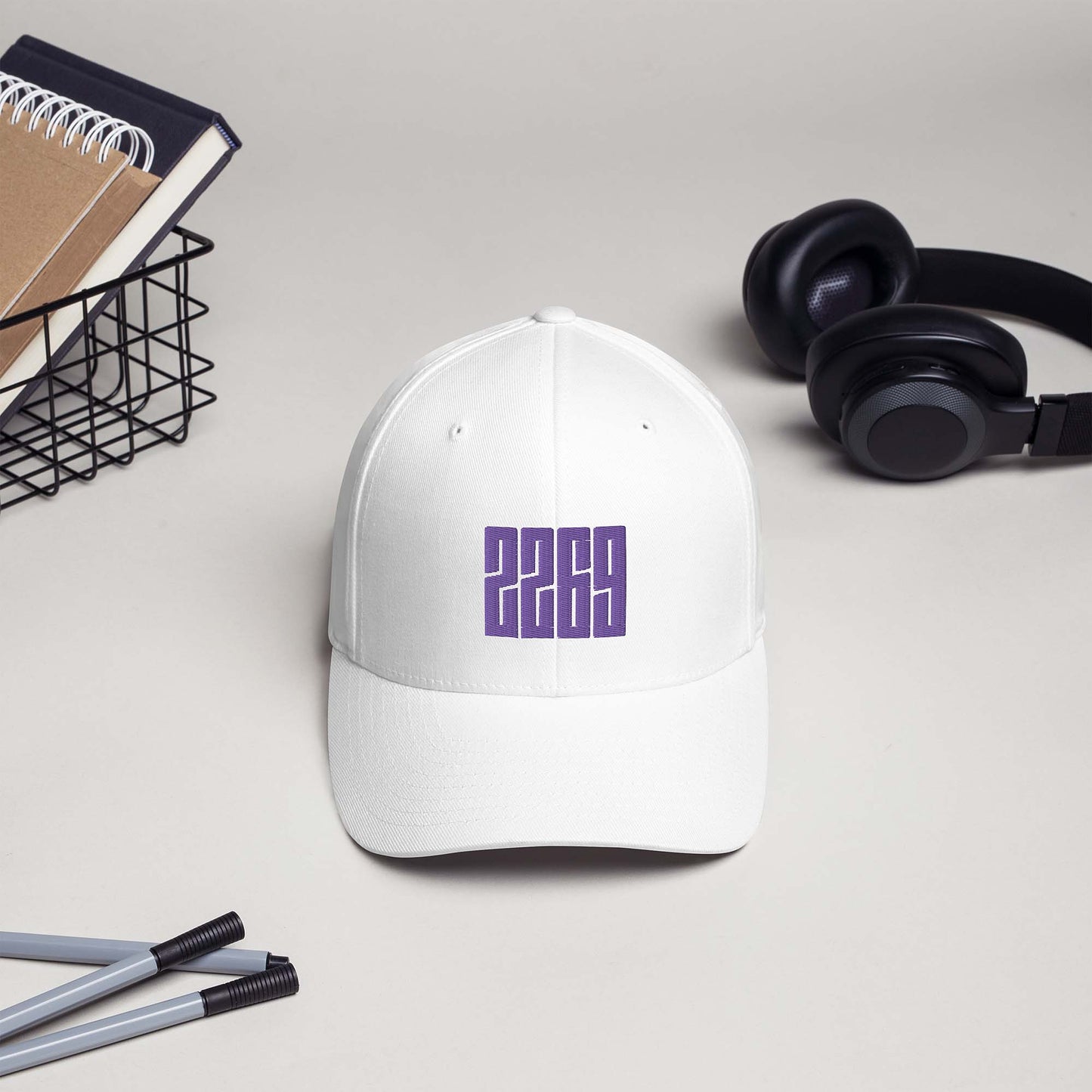 White fitted baseball hat with purple embroidery front and back