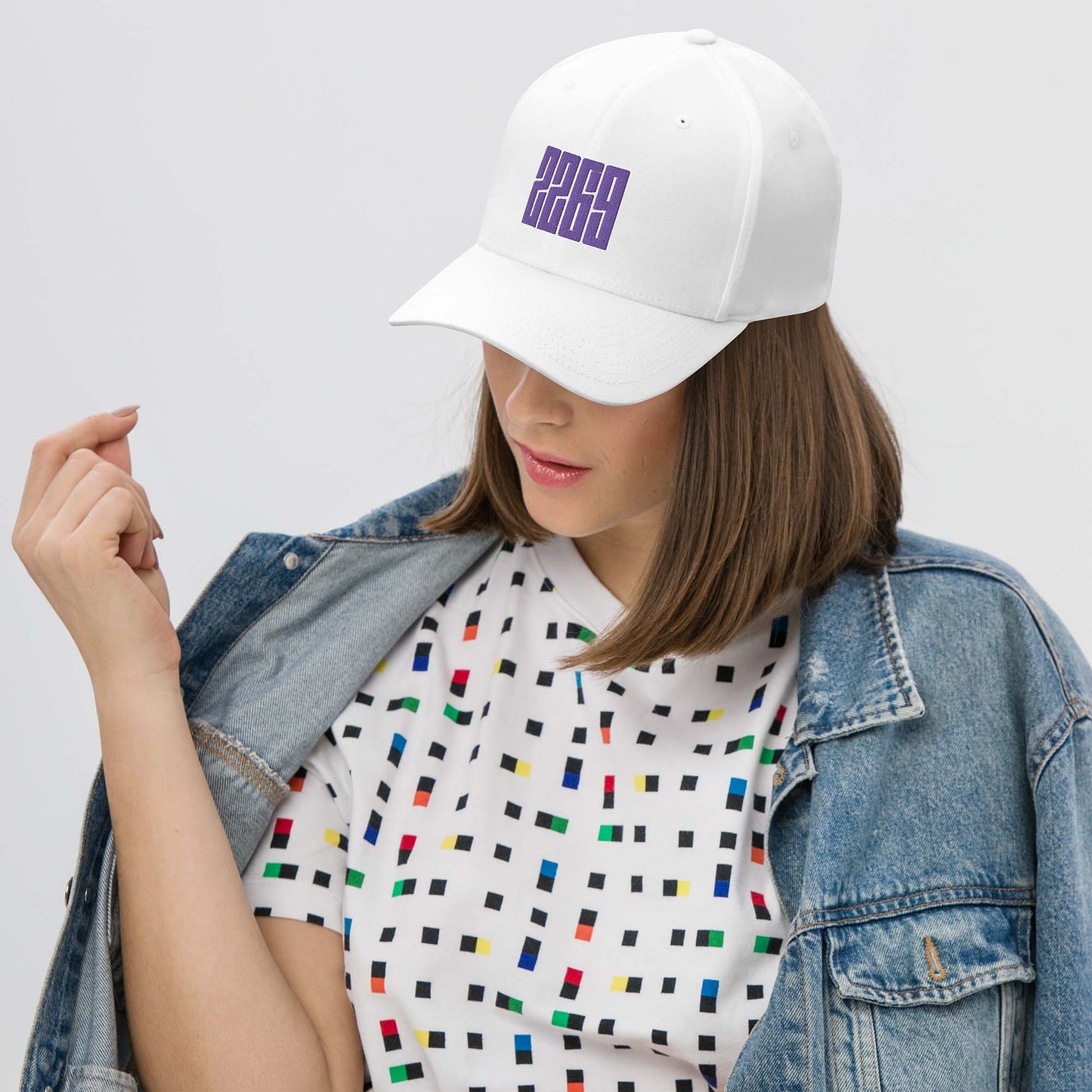 White fitted baseball hat with purple embroidery front and back