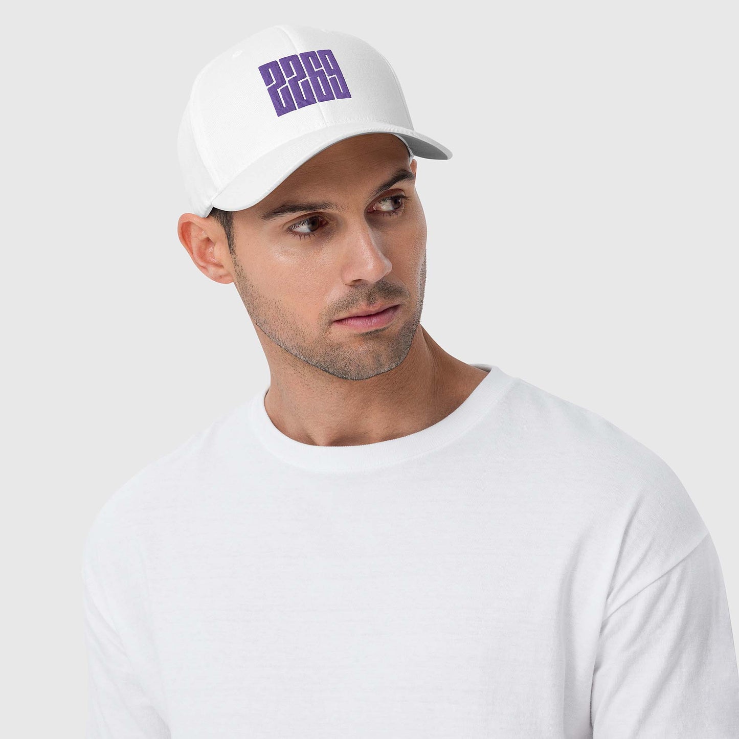 White fitted baseball hat with purple embroidery front and back